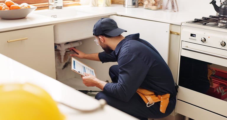 Handyman with clipboard inspection and maintenance