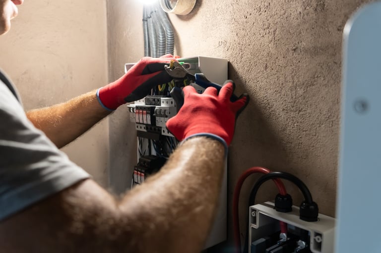 Electrician installing and maintaining an electrical panel
