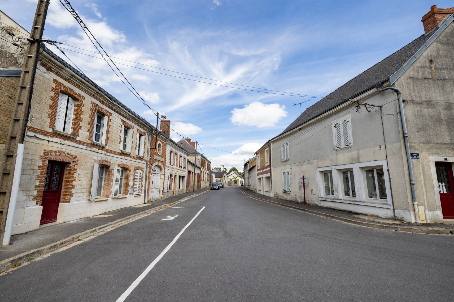 Quiet street with stone houses and a peaceful country road with stone residences