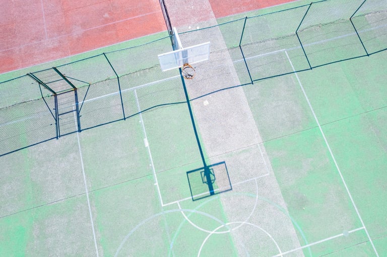 Empty sports court with geometric patterns from drone perspective